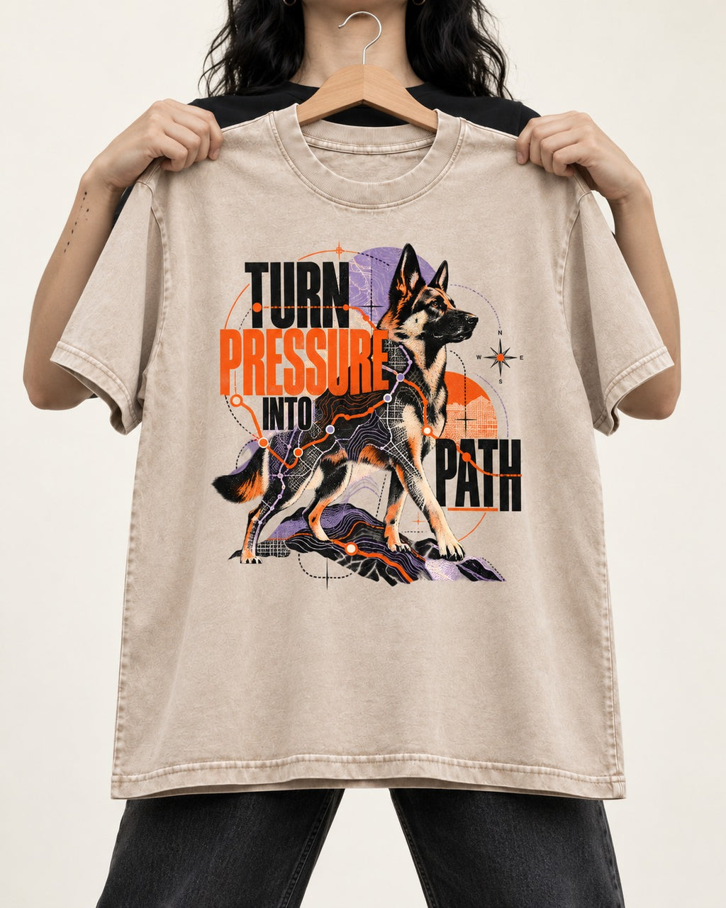 Turn Pressure Into Path German Shepherd Dog Washed Tee in Apricot, held up on a hanger