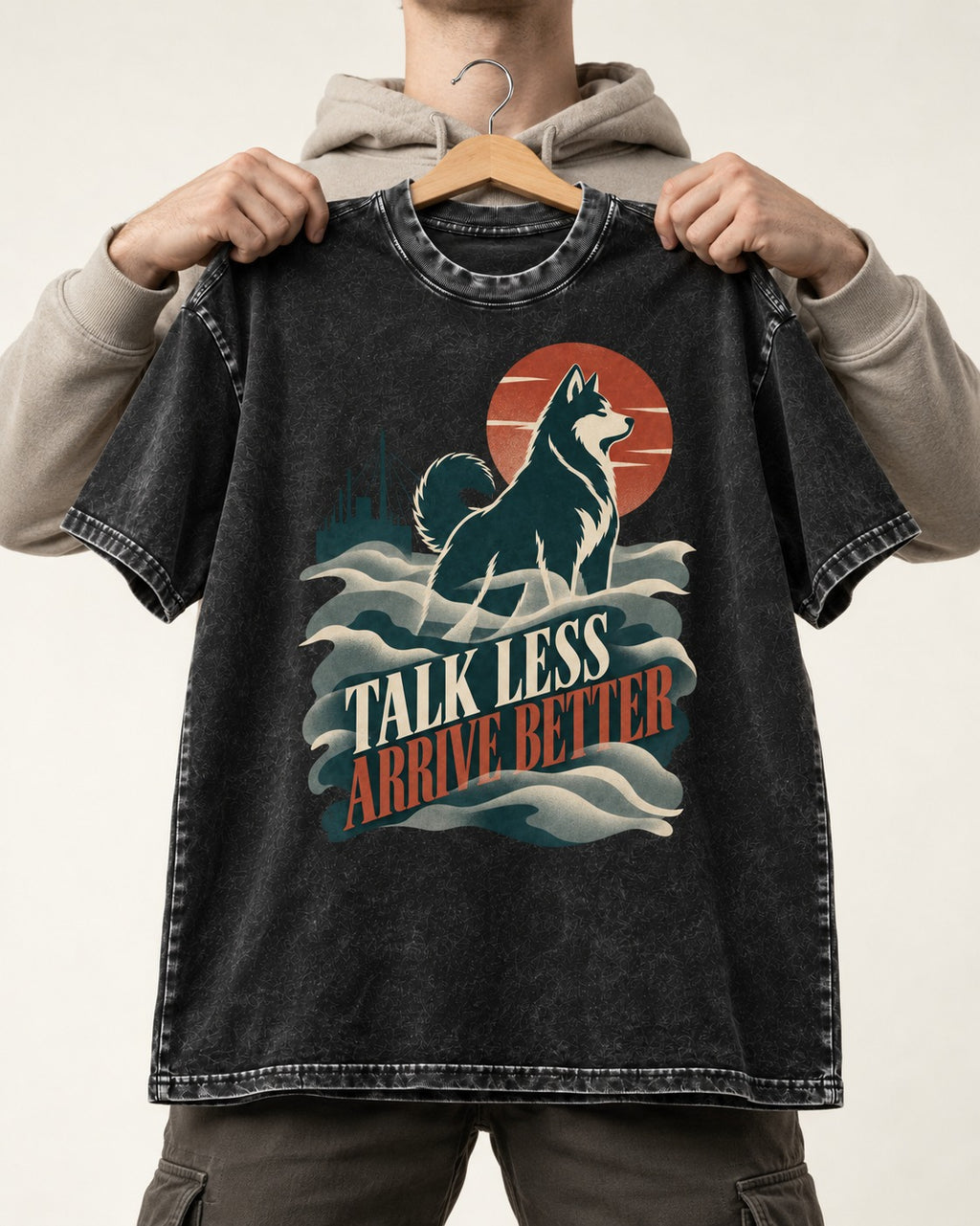 Husky Talk Less Arrive Better Harbor Wave Graphic Washed Tee in Black, held up on a hanger