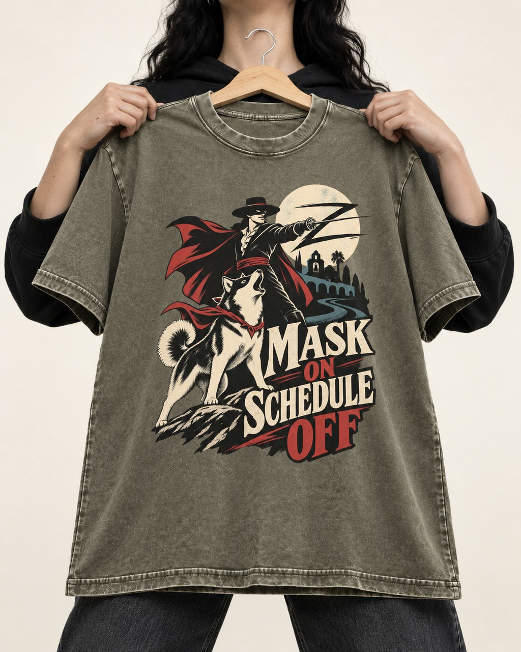 Husky Mask On Schedule Off Masked Swordsman Graphic Washed Tee in Army Green, held up on a hanger