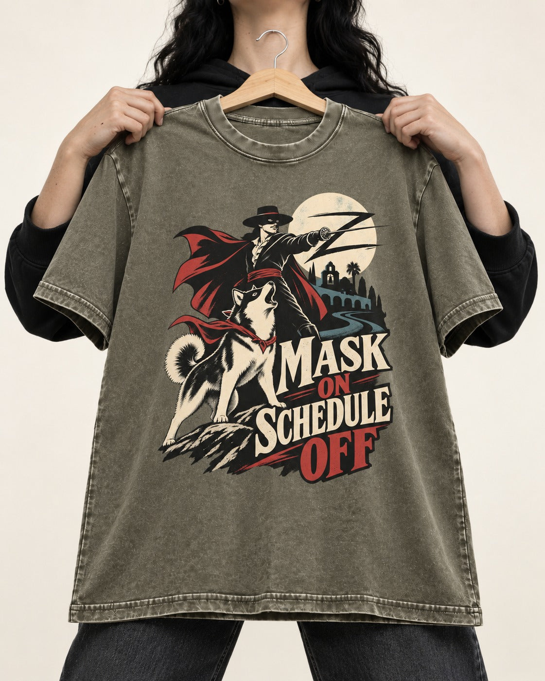 Husky Mask On Schedule Off Masked Swordsman Graphic Washed Tee in Army Green, held up on a hanger