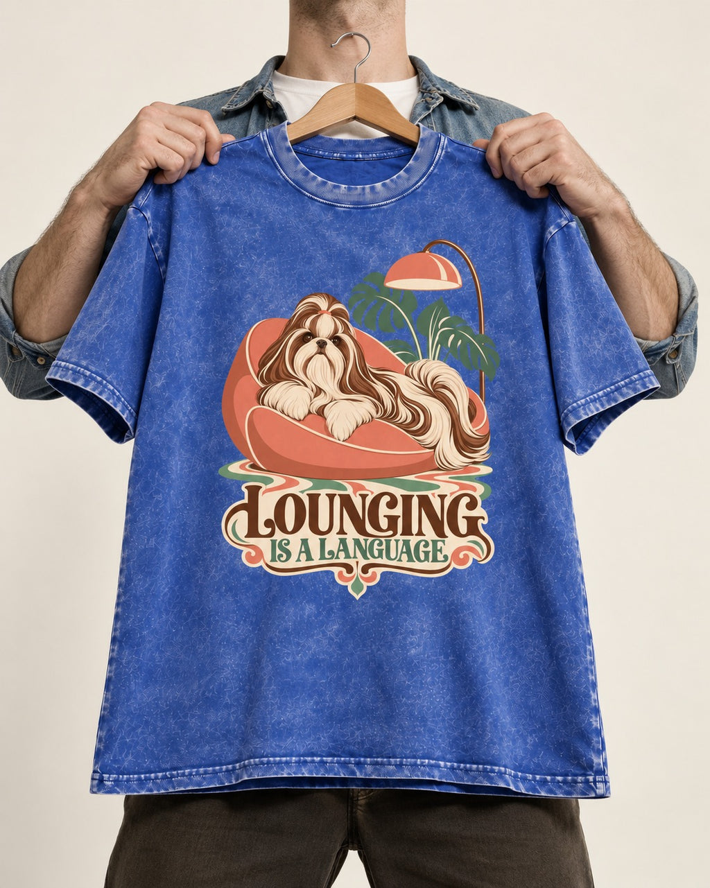 Shih Tzu Lounging Is a Language Retro Lounge Graphic Washed Tee in Royal Blue, held up on a hanger
