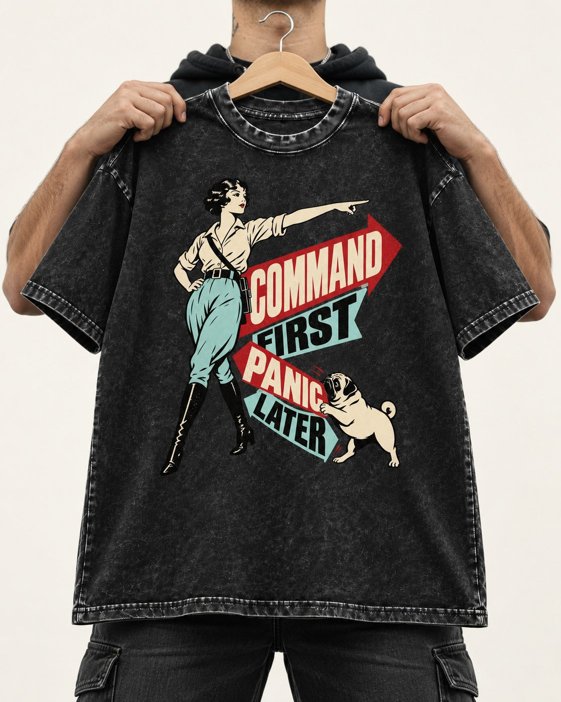 Pug Command First Panic Later Directional Graphic Washed Tee in Black, held up on a hanger