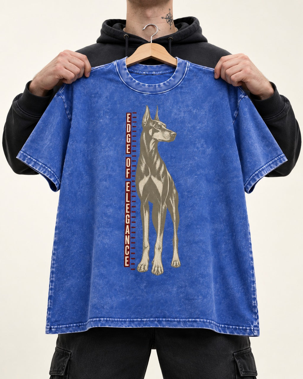 Doberman Edge of Elegance Height Chart Graphic Washed Tee in Royal Blue, held up on a hanger