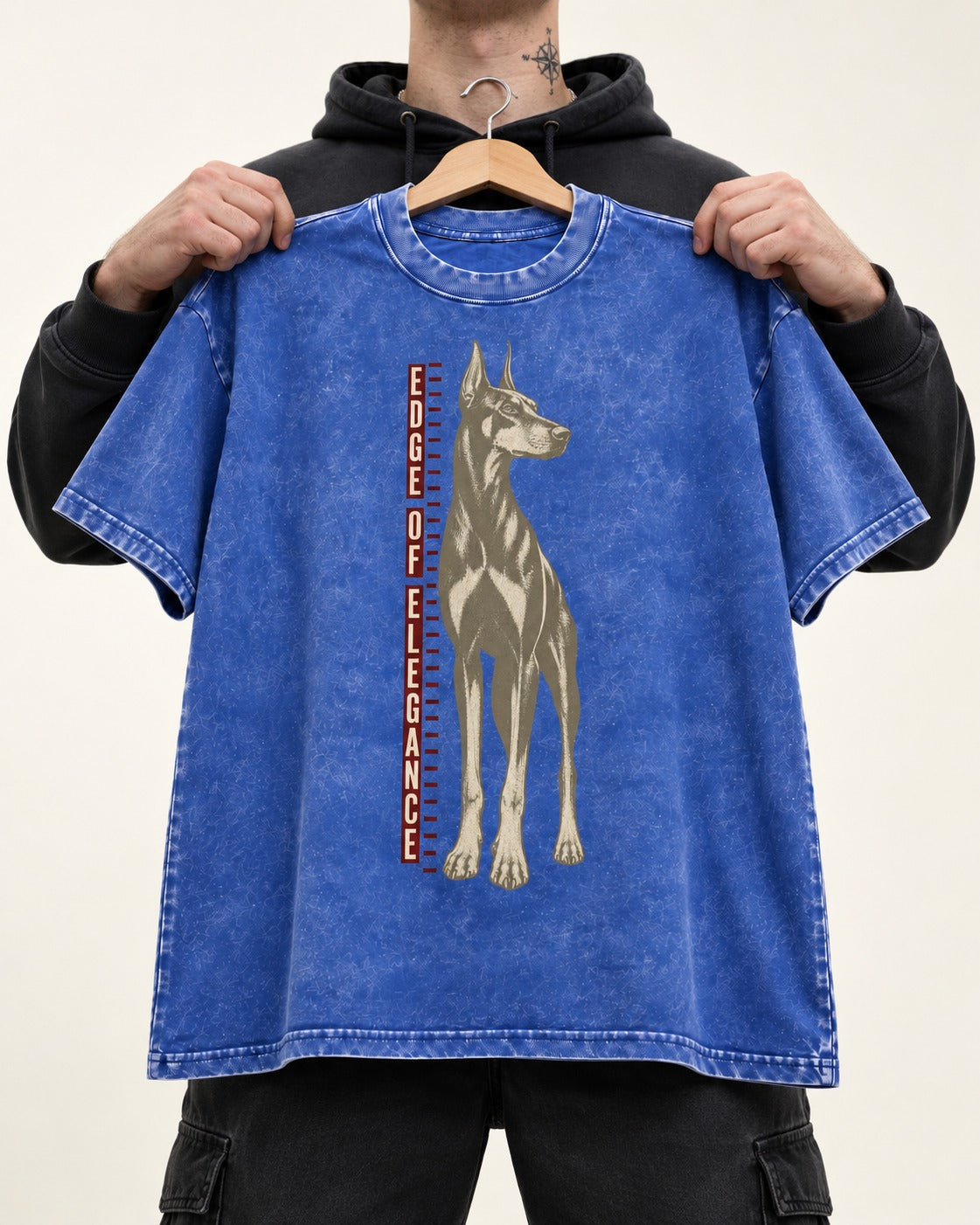 Doberman Edge of Elegance Height Chart Graphic Washed Tee in Royal Blue, held up on a hanger