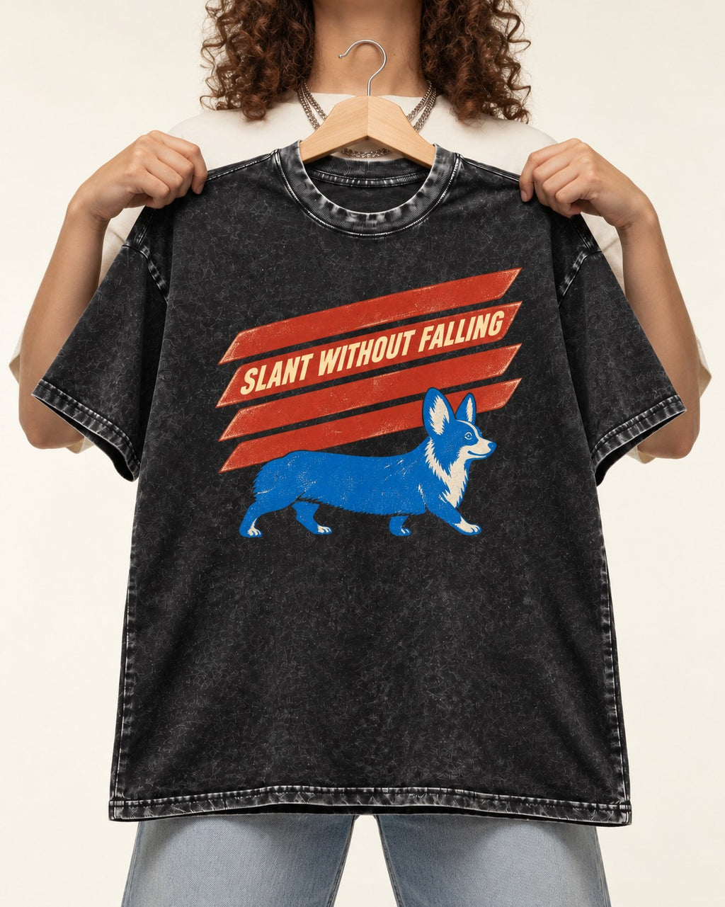 Corgi Slant Without Falling Speed Graphic Washed Tee in Black, held up on a hanger