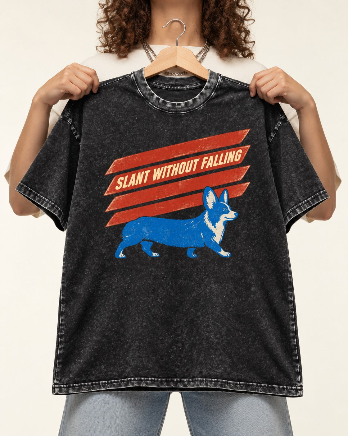 Corgi Slant Without Falling Speed Graphic Washed Tee in Black, held up on a hanger
