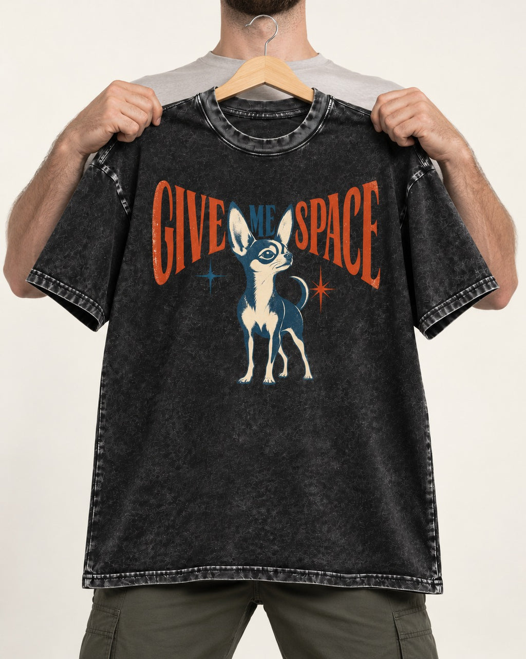 Chihuahua Give Me Space Starburst Graphic Washed Tee in Black, held up on a hanger