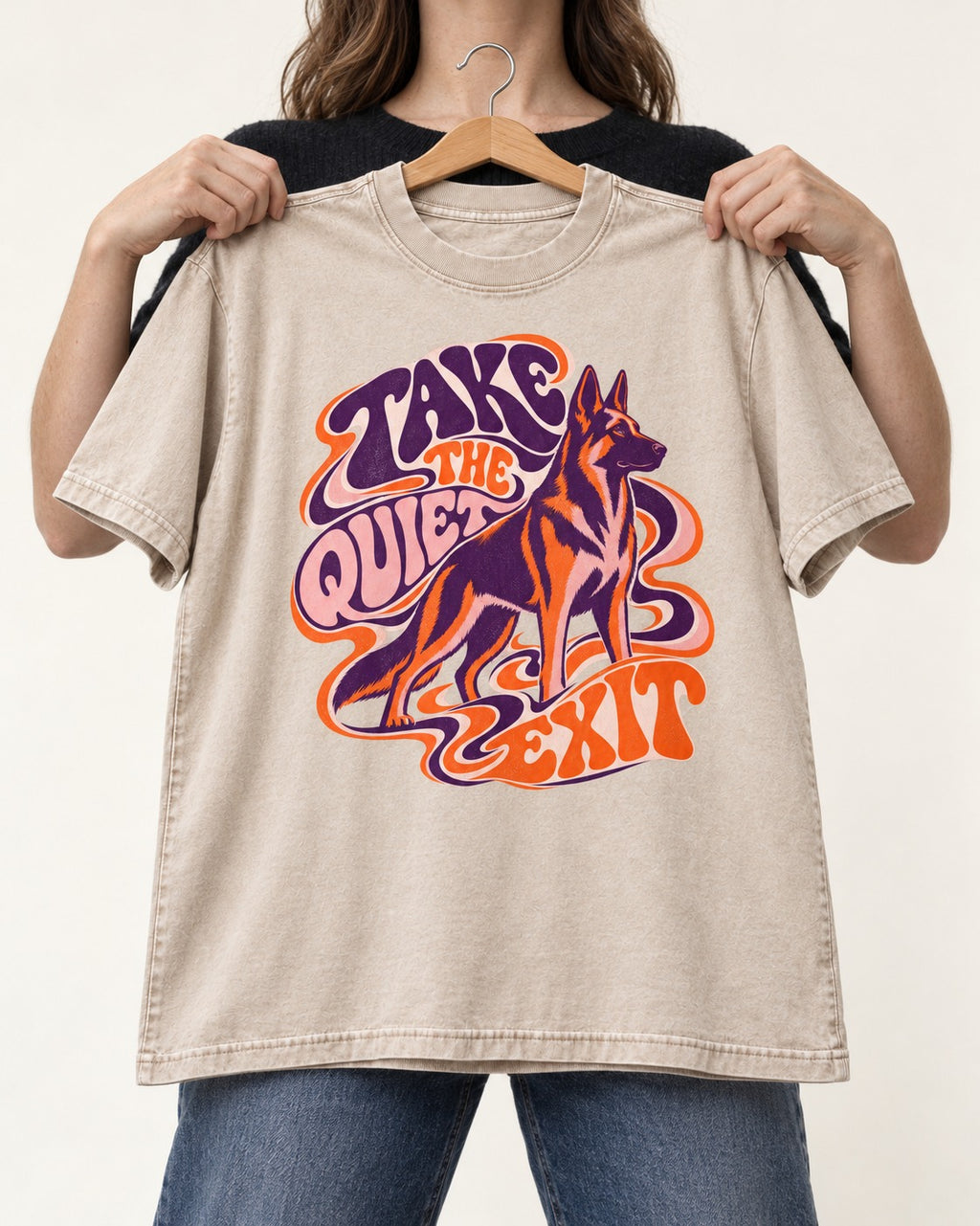 Take The Quiet Exit Psychedelic German Shepherd Dog Graphic Washed Tee in Apricot, held up on a hanger