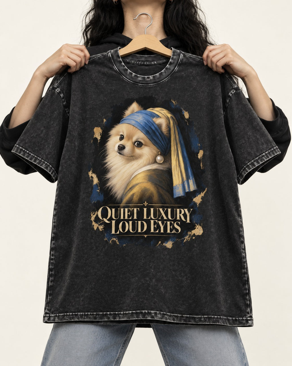 Pomeranian Quiet Luxury Loud Eyes Pearl Portrait Graphic Washed Tee in Black, held up on a hanger