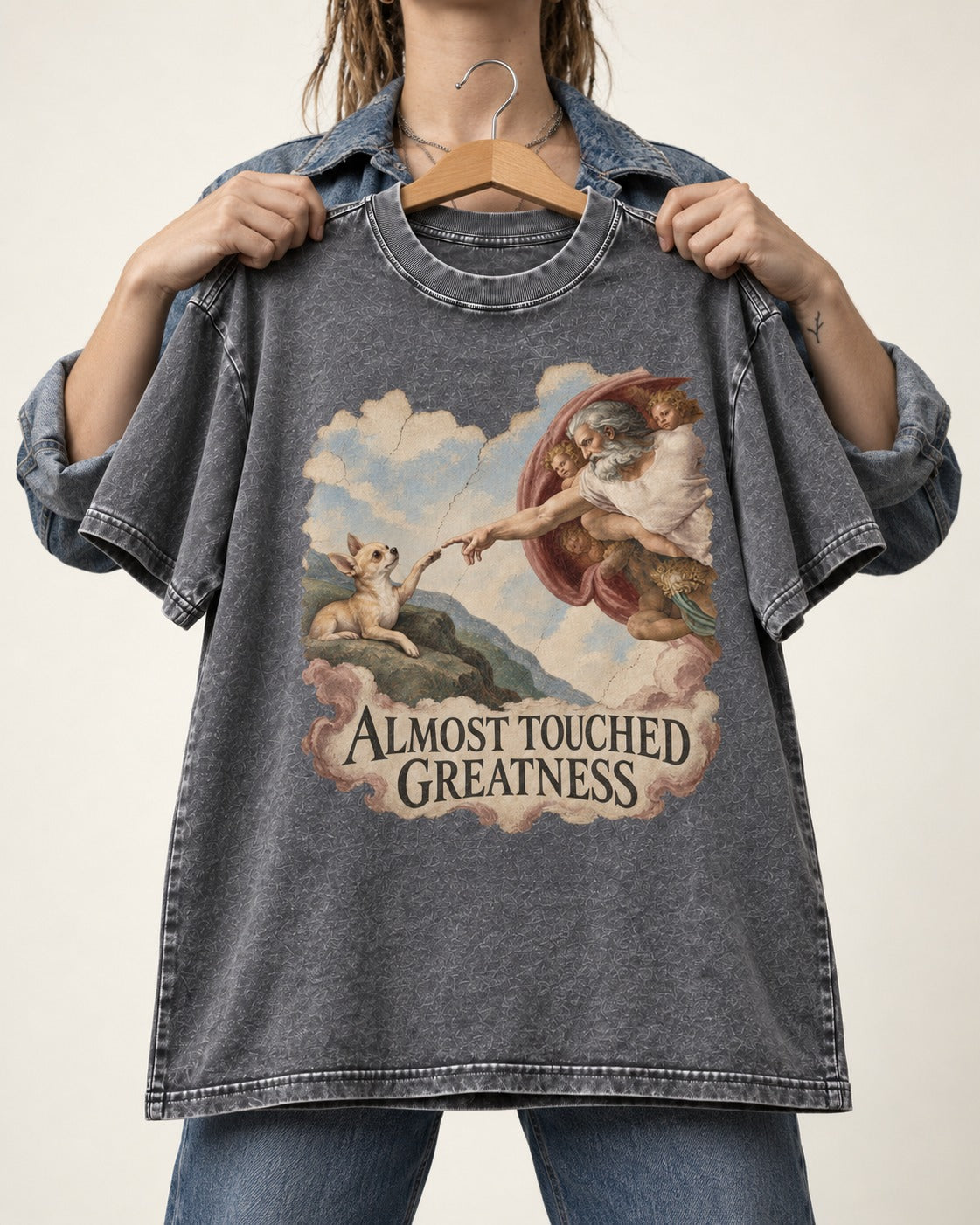 Chihuahua Almost Touched Greatness Renaissance Parody Washed Tee in Gray, held up on a hanger