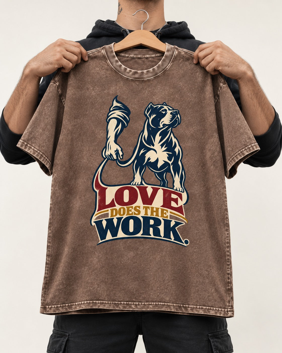 Pitbull Love Does the Work Washed Tee in Coffee, held up on a hanger