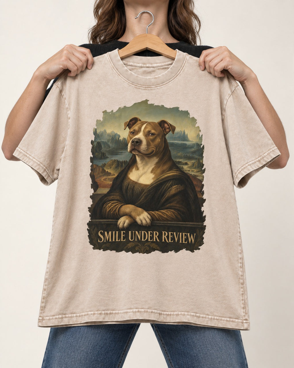Pitbull Smile Under Review Renaissance Portrait Graphic Washed Tee in Apricot, held up on a hanger