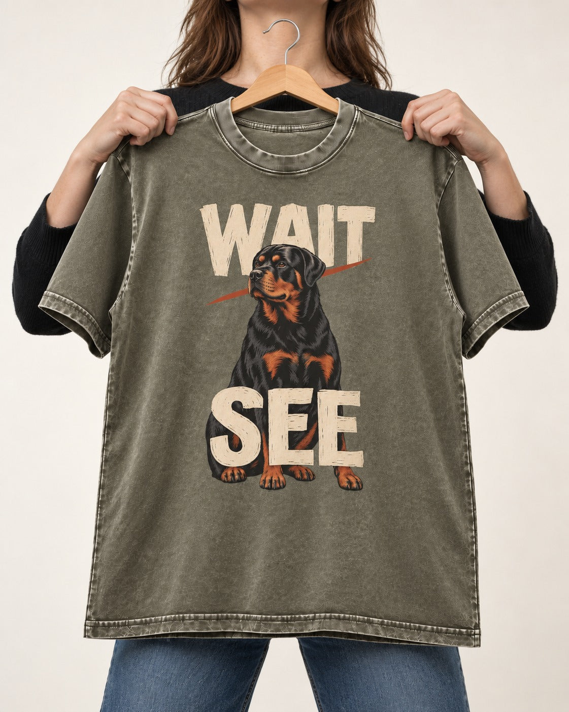 Wait See Rottweiler Seated Slash Graphic Washed Tee in Army Green, held up on a hanger