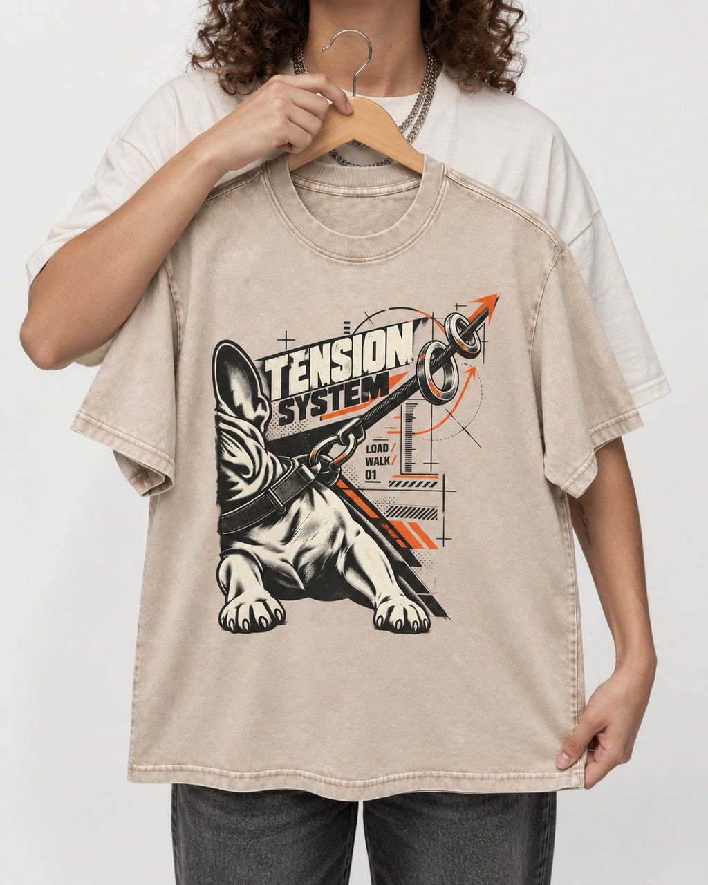 Frenchie Tension System Washed Tee in Apricot, held up on a hanger