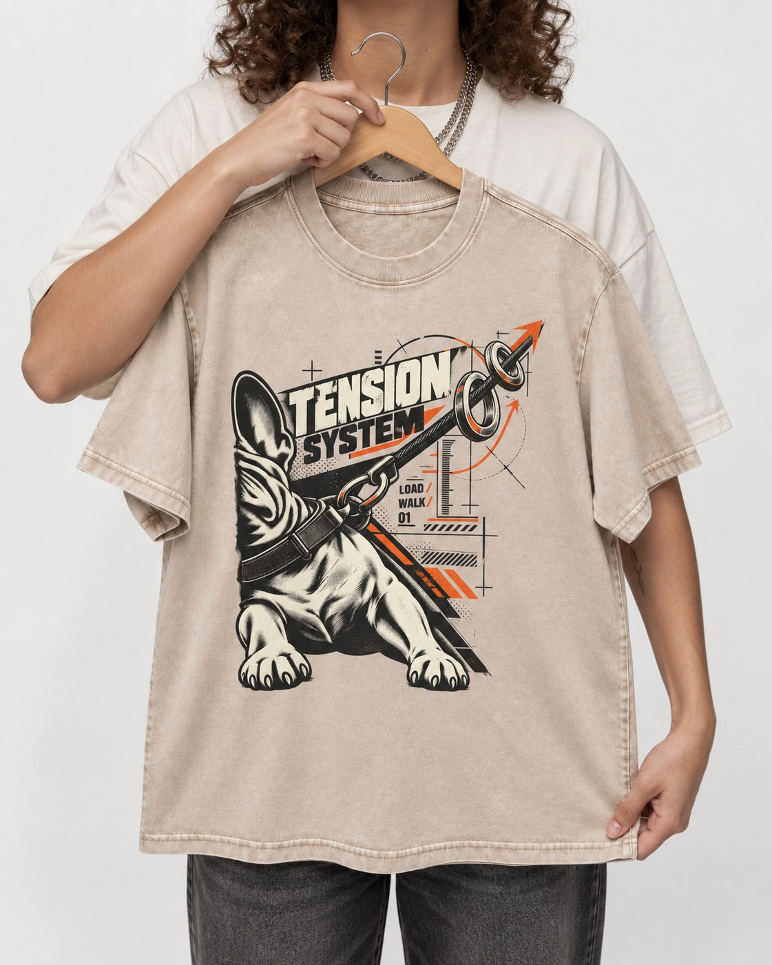 Frenchie Tension System Washed Tee in Apricot, held up on a hanger