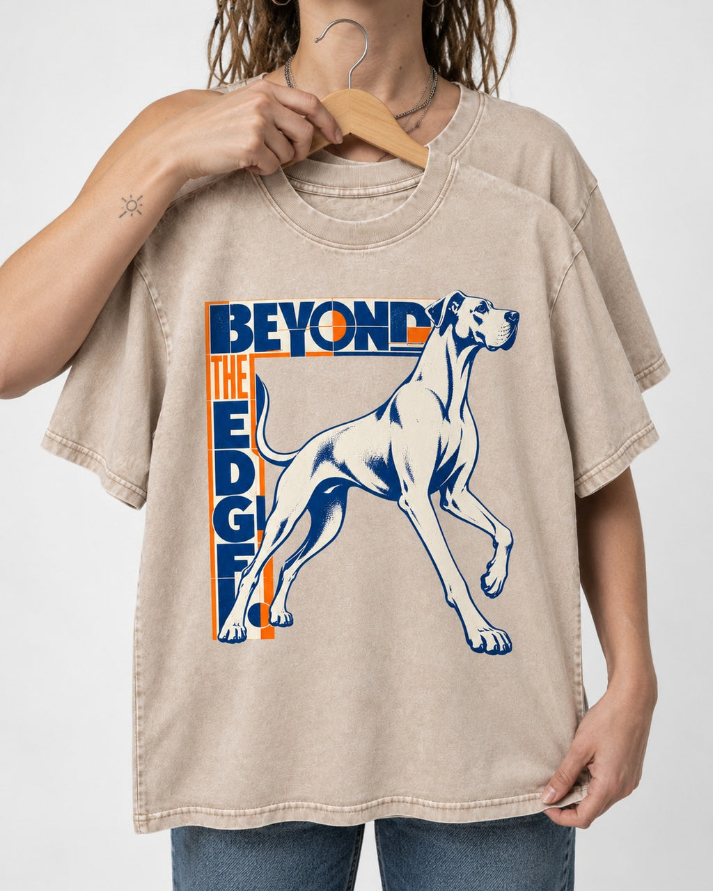 Great Dane Beyond the Edge Washed Tee in Apricot, held up on a hanger