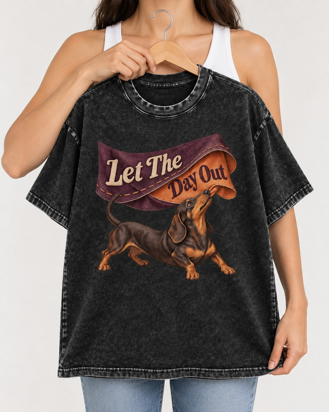 Dachshund Let The Day Out Fabric Banner Graphic Washed Tee in Black, held up on a hanger