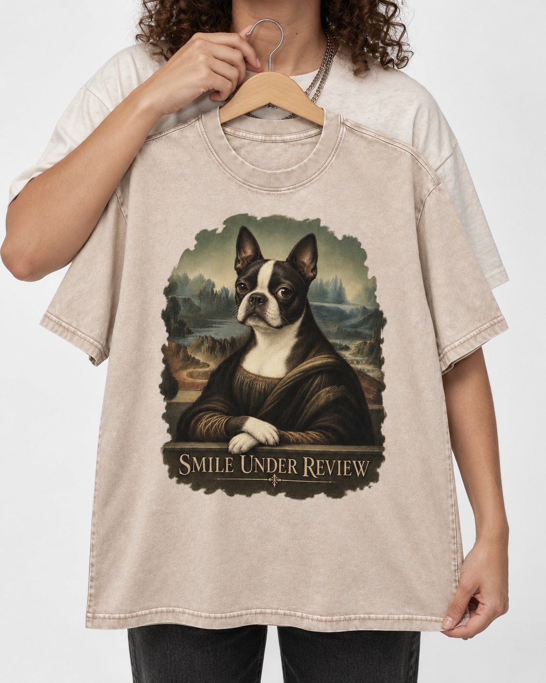 Smile Under Review Boston Terrier Mona Lisa Portrait Washed Tee in Apricot, held up on a hanger