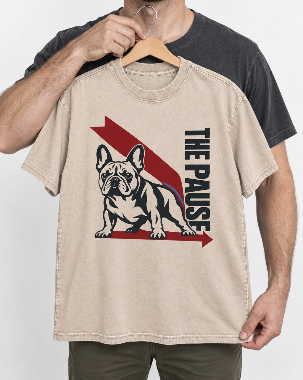 The Frenchie Pause Washed Tee in Apricot, held up on a hanger