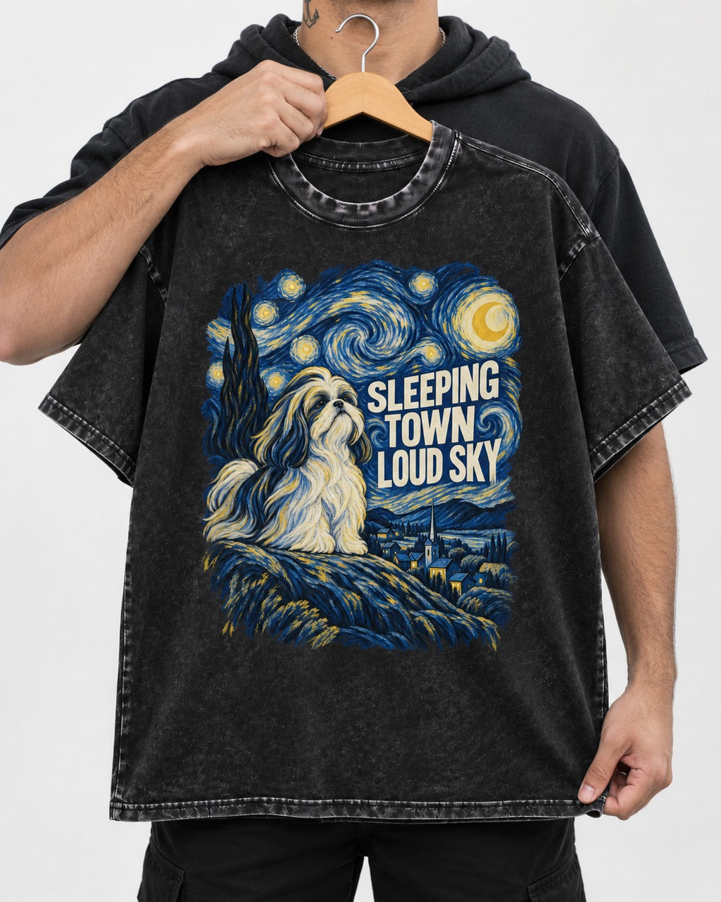 Shih Tzu Sleeping Town Loud Sky Swirling Night Graphic Washed Tee in Black, held up on a hanger