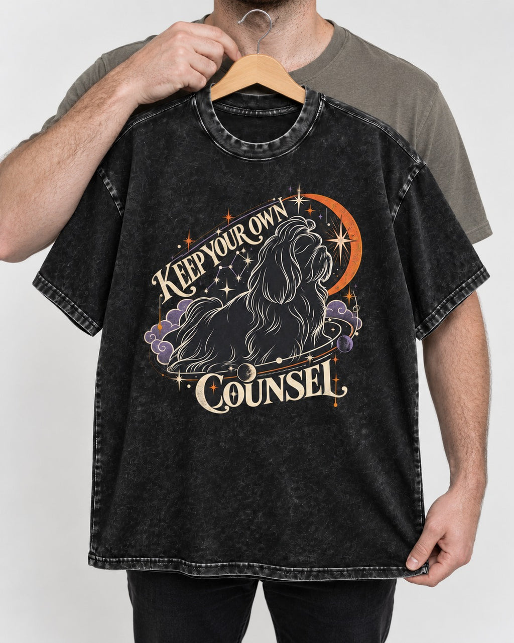 Shih Tzu Keep Your Own Counsel Celestial Graphic Washed Tee in Black, held up on a hanger