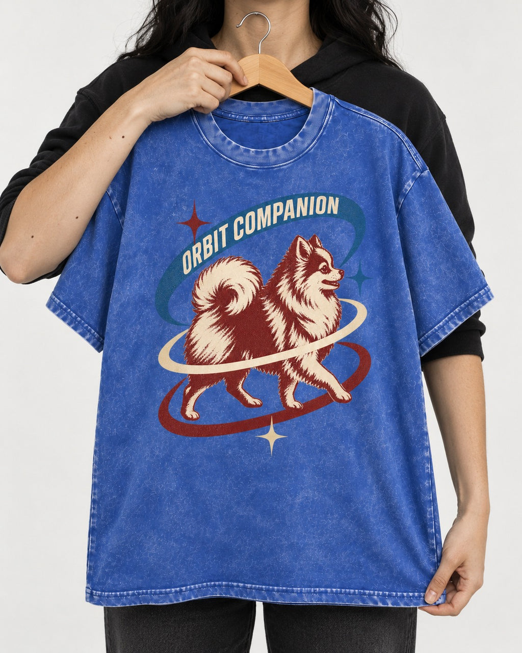 Pomeranian Orbit Companion Retro Space Graphic Washed Tee in Royal Blue, held up on a hanger