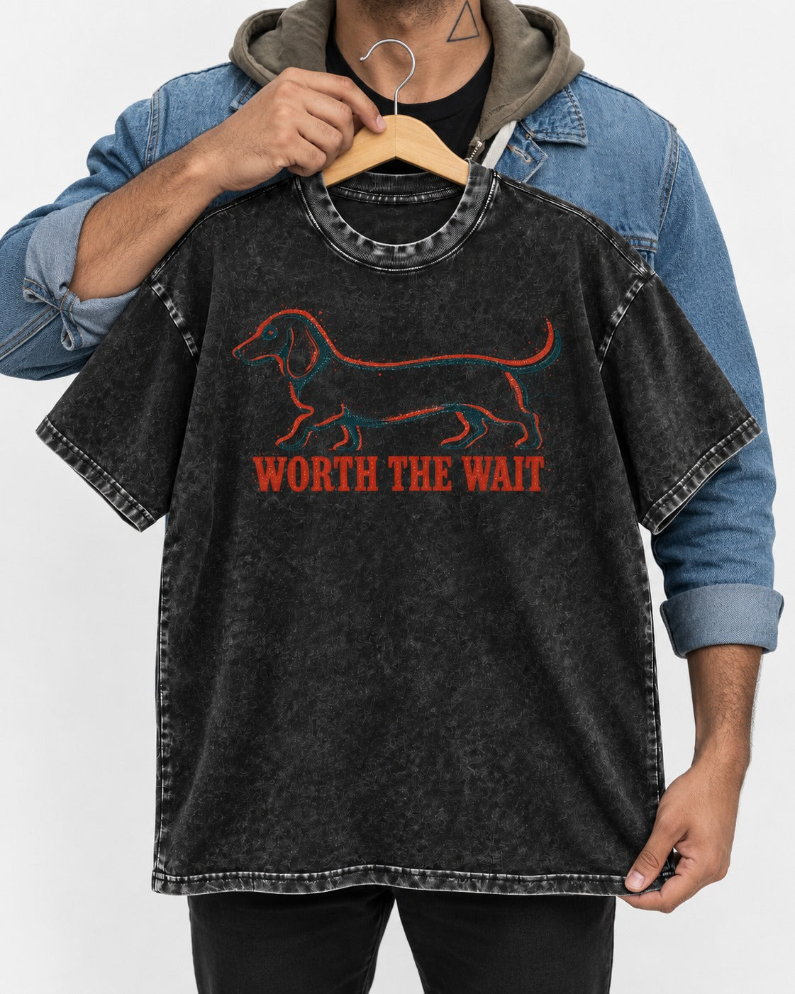 Dachshund Worth The Wait Distressed Outline Graphic Washed Tee in Black, held up on a hanger