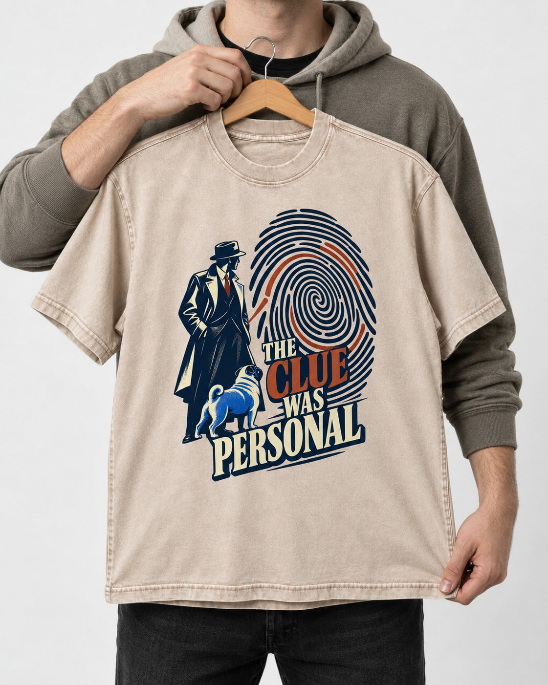 The Pug Clue Was Personal Washed Tee in Apricot, held up on a hanger