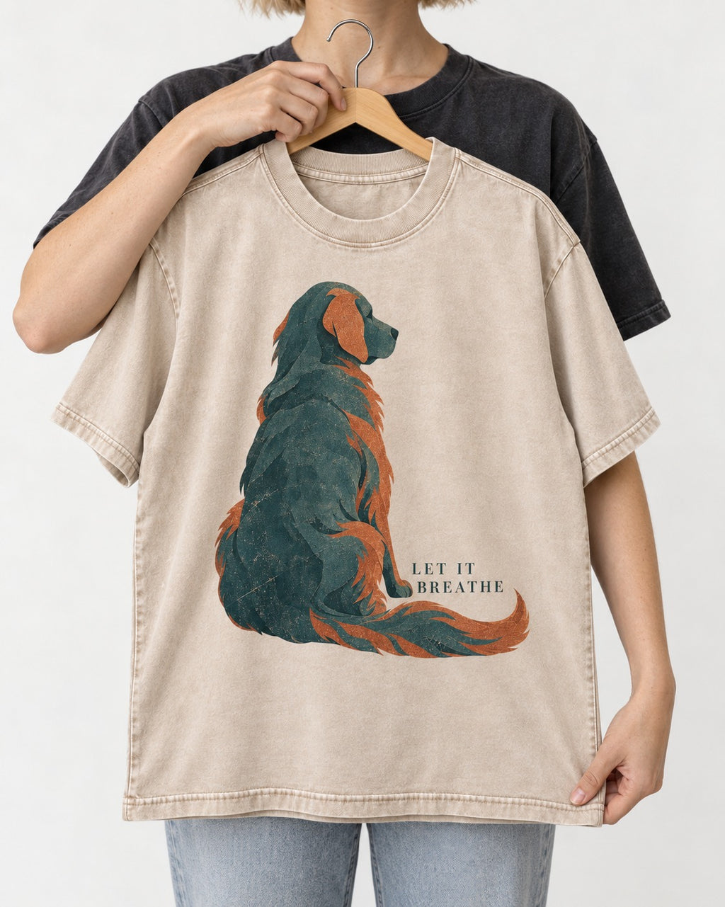Let It Breathe Golden Retriever Washed Tee in Apricot, held up on a hanger