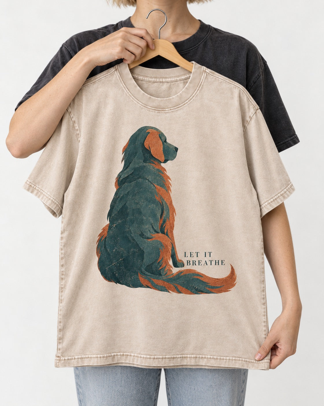 Let It Breathe Golden Retriever Washed Tee in Apricot, held up on a hanger