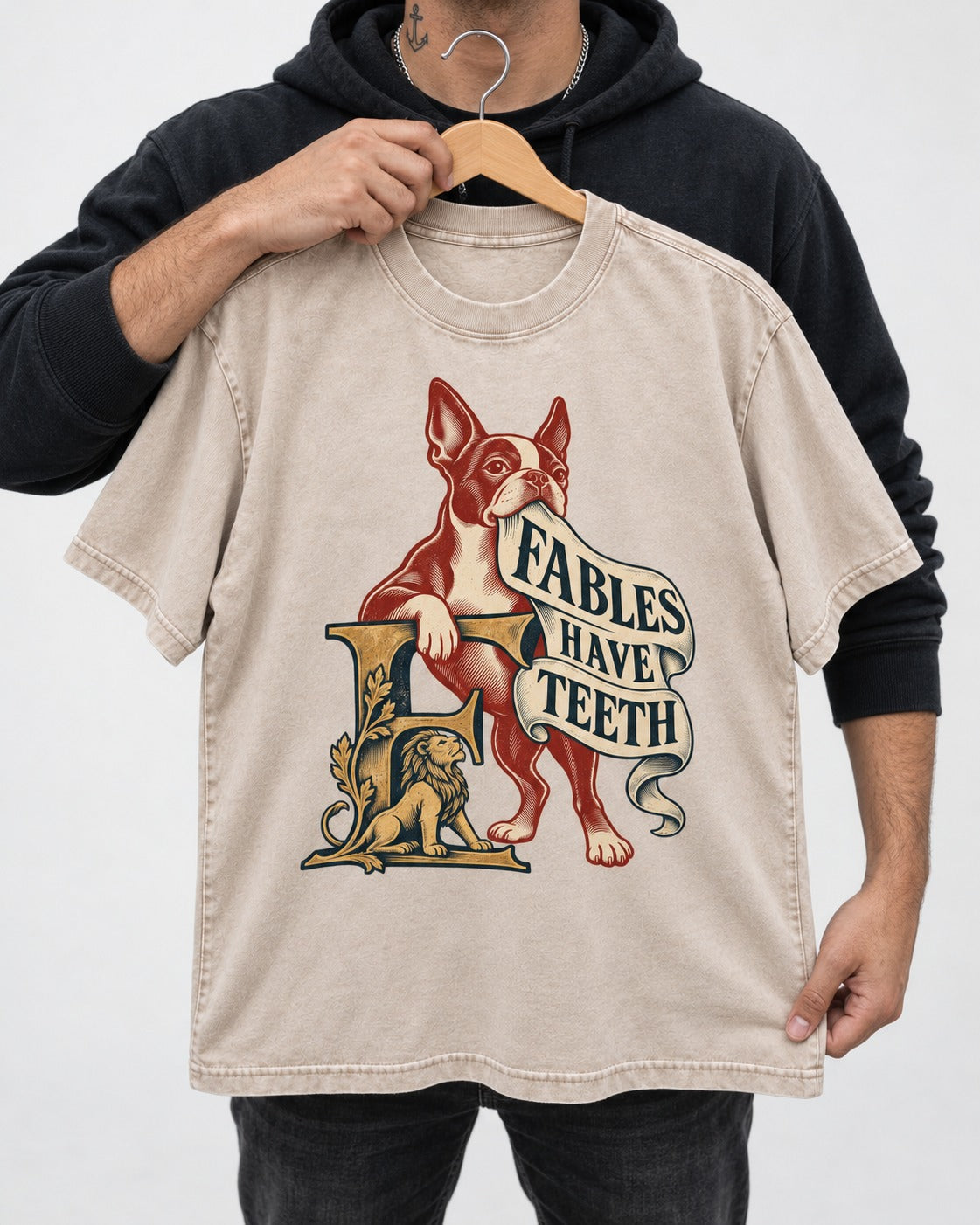 Boston Terrier Fables Have Teeth Washed Tee in Apricot, held up on a hanger