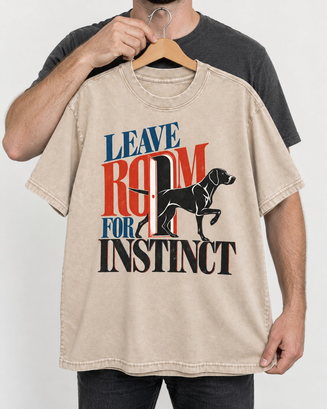 Leave Room for Instinct German Shorthaired Pointer Washed Tee in Apricot, held up on a hanger
