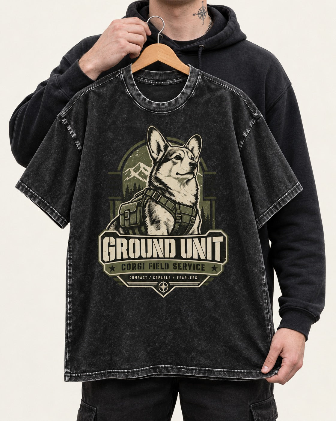 Corgi Ground Unit Field Service Badge Washed Tee in Black, held up on a hanger