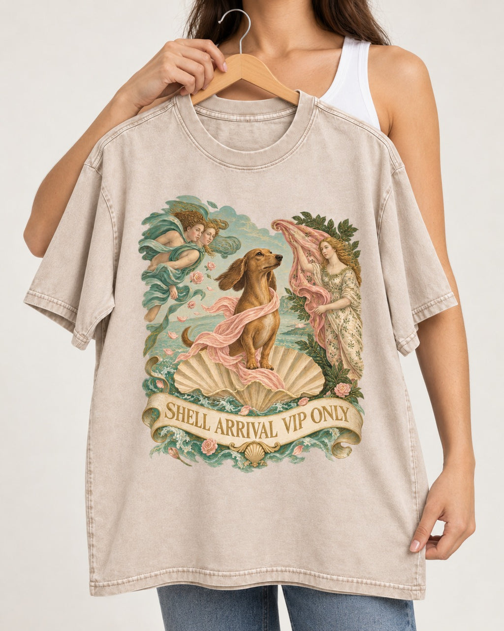 Dachshund Shell Arrival VIP Only Venus Parody Graphic Washed Tee in Apricot, held up on a hanger