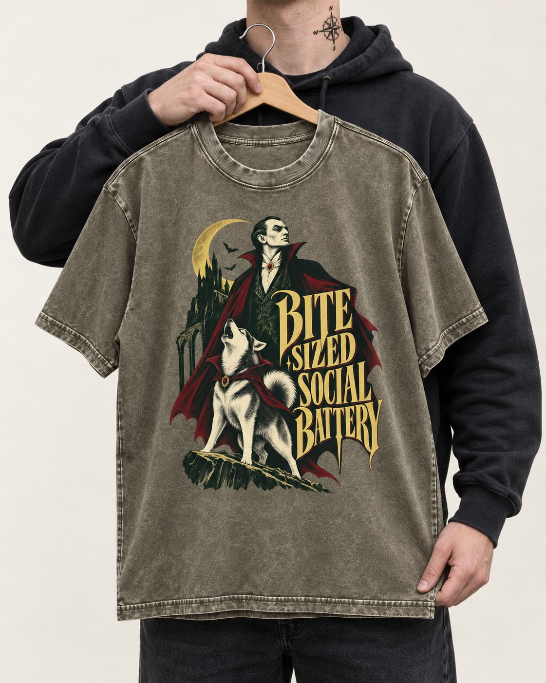 Husky Bite Sized Social Battery Vampire Graphic Washed Tee in Army Green, held up on a hanger