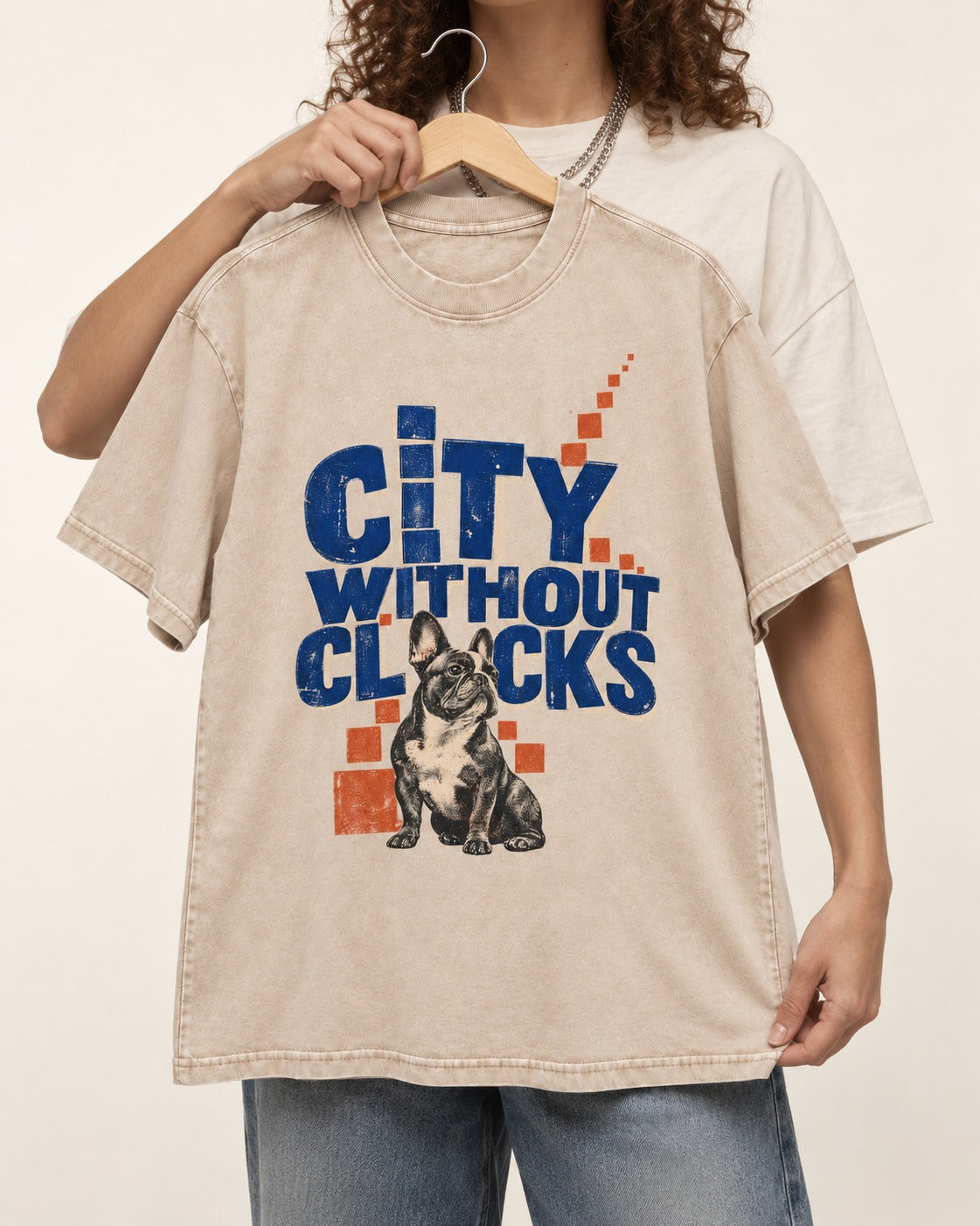 Frenchie's City Without Clocks Washed Tee in Apricot, held up on a hanger