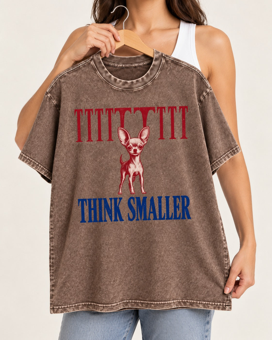 Think Smaller Chihuahua Washed Tee in Coffee, held up on a hanger