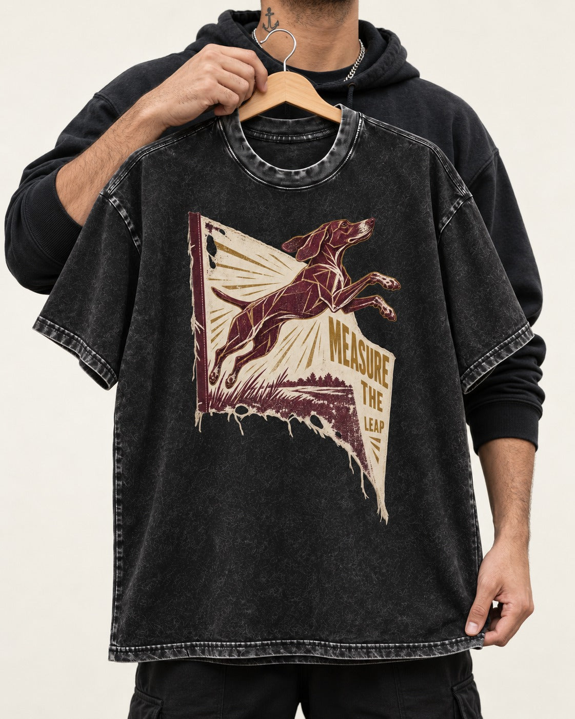 German Shorthaired Pointer Measure the Leap Torn Banner Graphic Washed Tee in Black, held up on a hanger