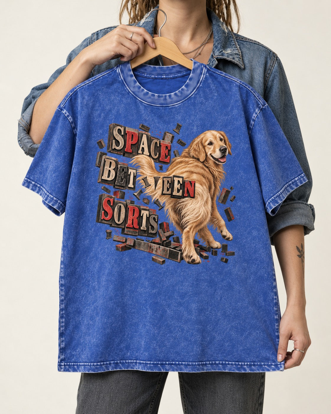 Golden Retriever Space Between Sorts Letterpress Graphic Washed Tee in Royal Blue, held up on a hanger