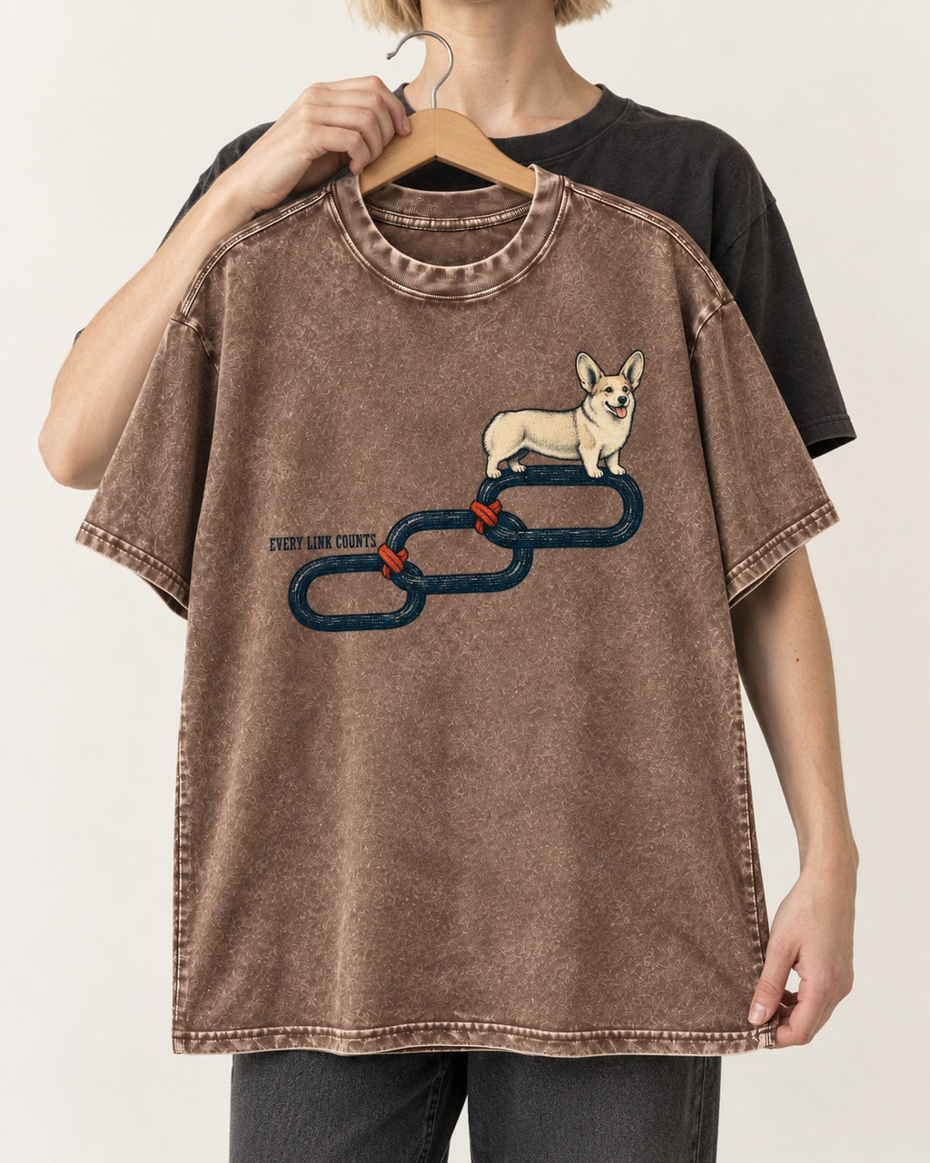 Every Corgi Link Counts Washed Tee in Coffee, held up on a hanger