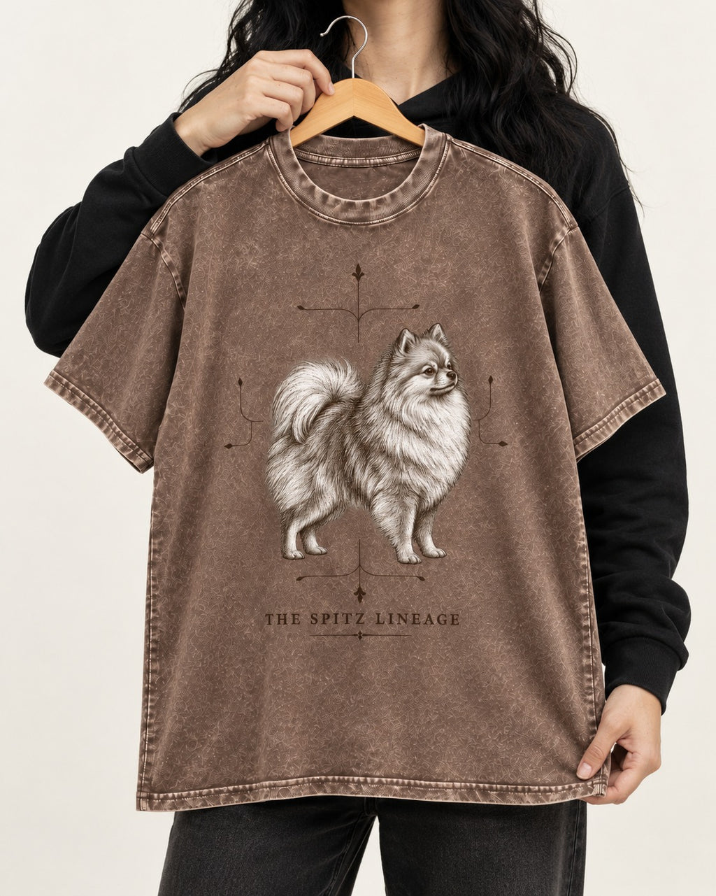 Pomeranian Spitz Lineage Washed Tee in Coffee, held up on a hanger