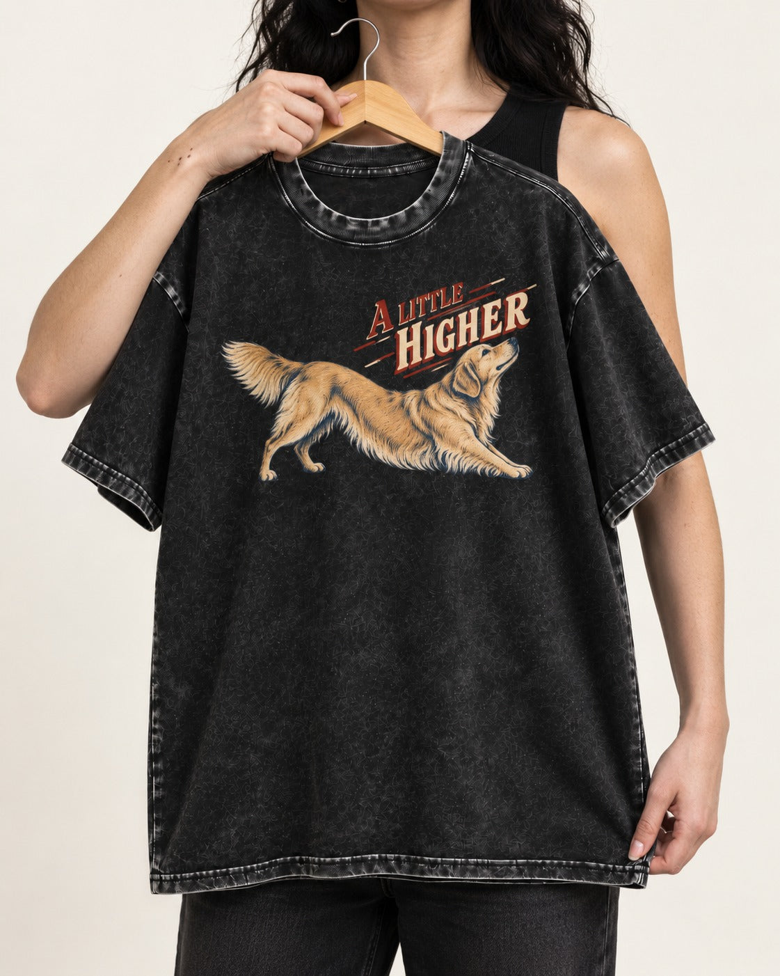 Golden Retriever A Little Higher Play Bow Graphic Washed Tee in Black, held up on a hanger