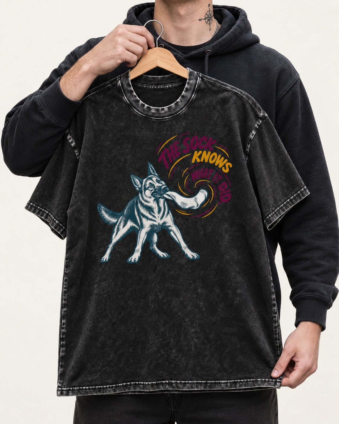 German Shepherd Dog The Sock Knows What I Did Graphic Washed Tee in Black, held up on a hanger