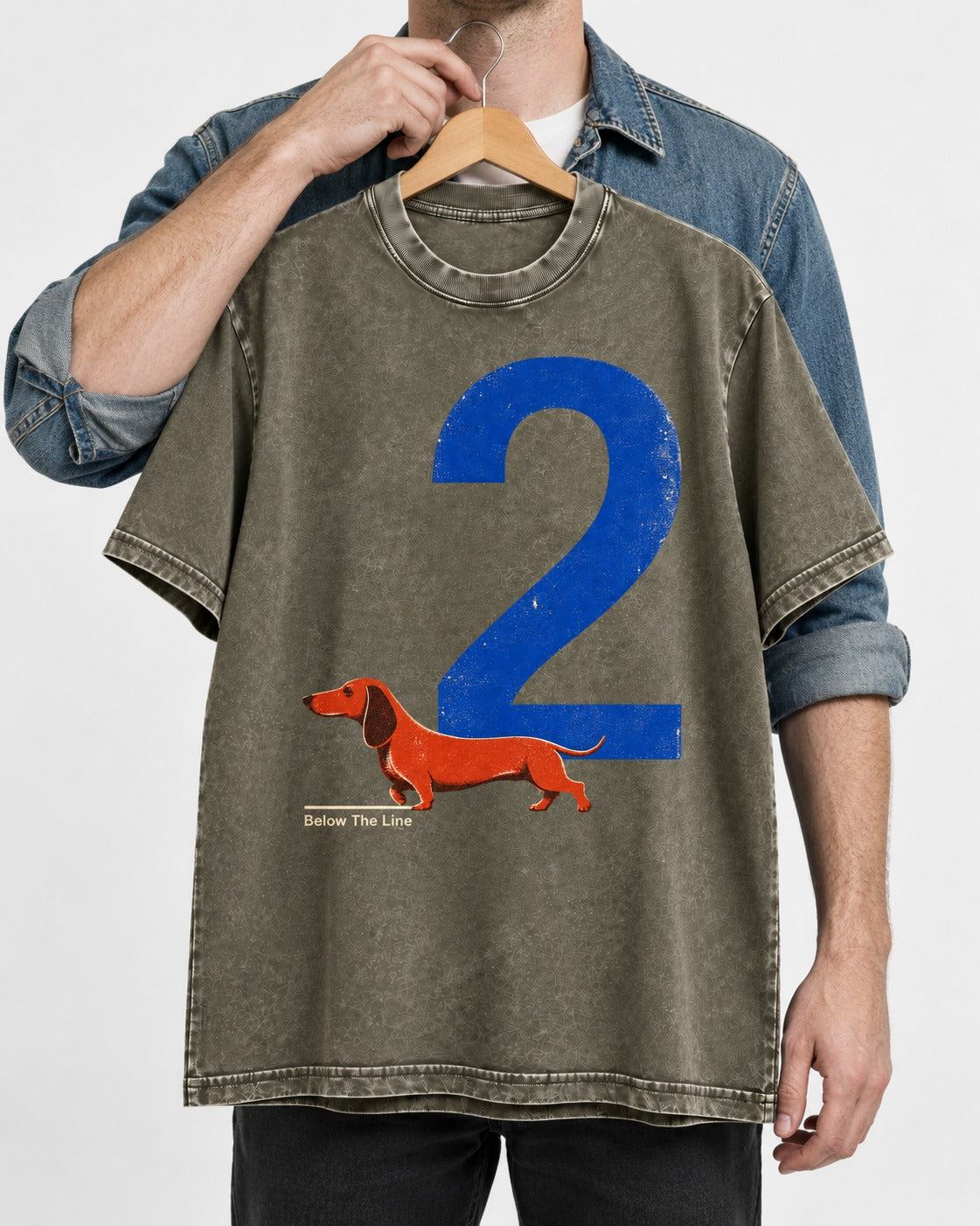 Dachshund Below The Line Number Two Graphic Washed Tee in Army Green, held up on a hanger