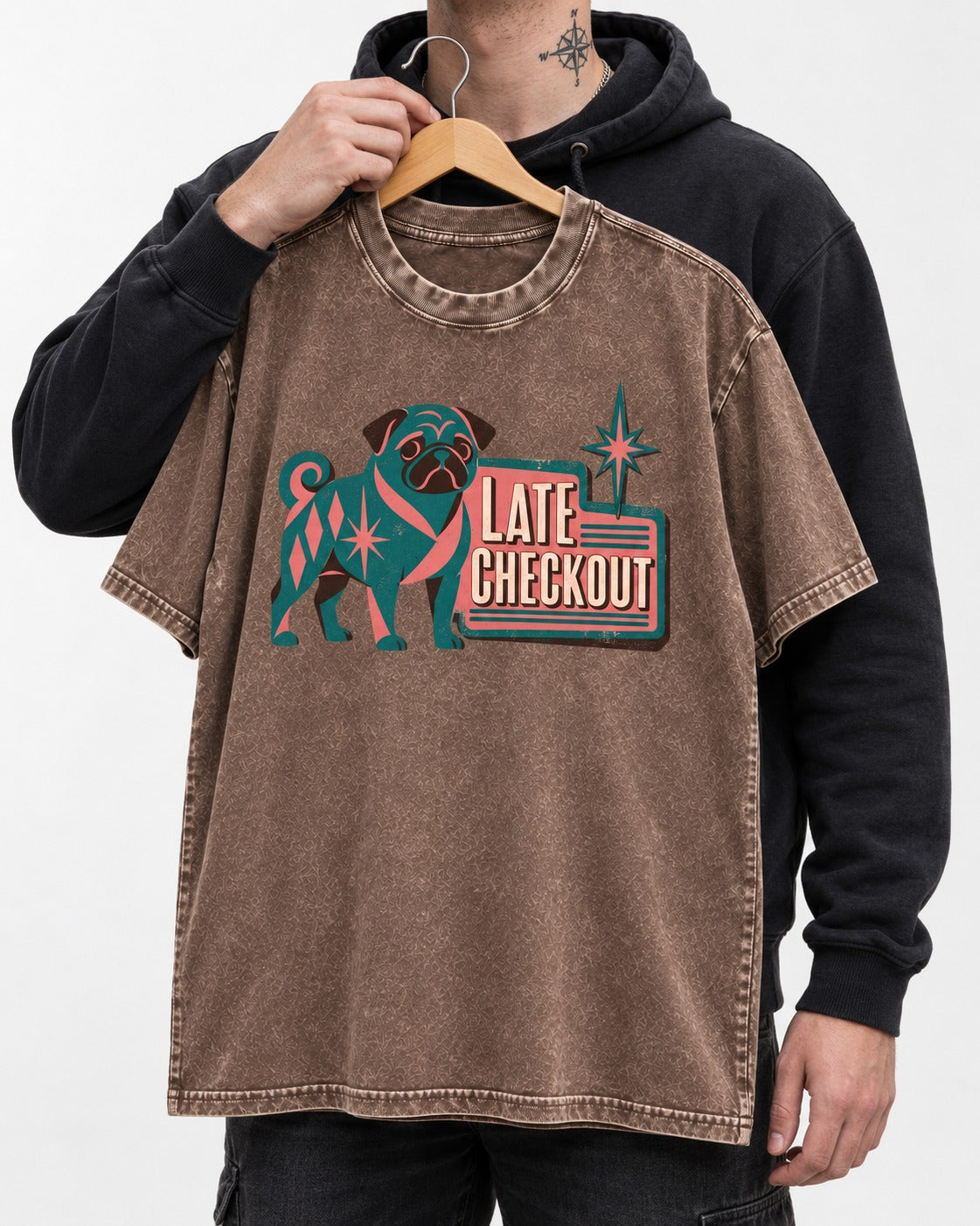 Pug's Late Checkout Washed Tee in Coffee, held up on a hanger