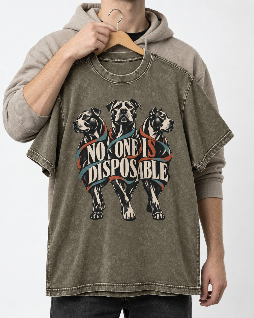 Pitbull No One Is Disposable Three Dogs Graphic Washed Tee in Army Green, held up on a hanger