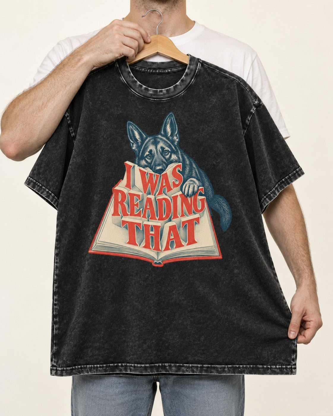 German Shepherd Dog I Was Reading That Open Book Graphic Washed Tee in Black, held up on a hanger