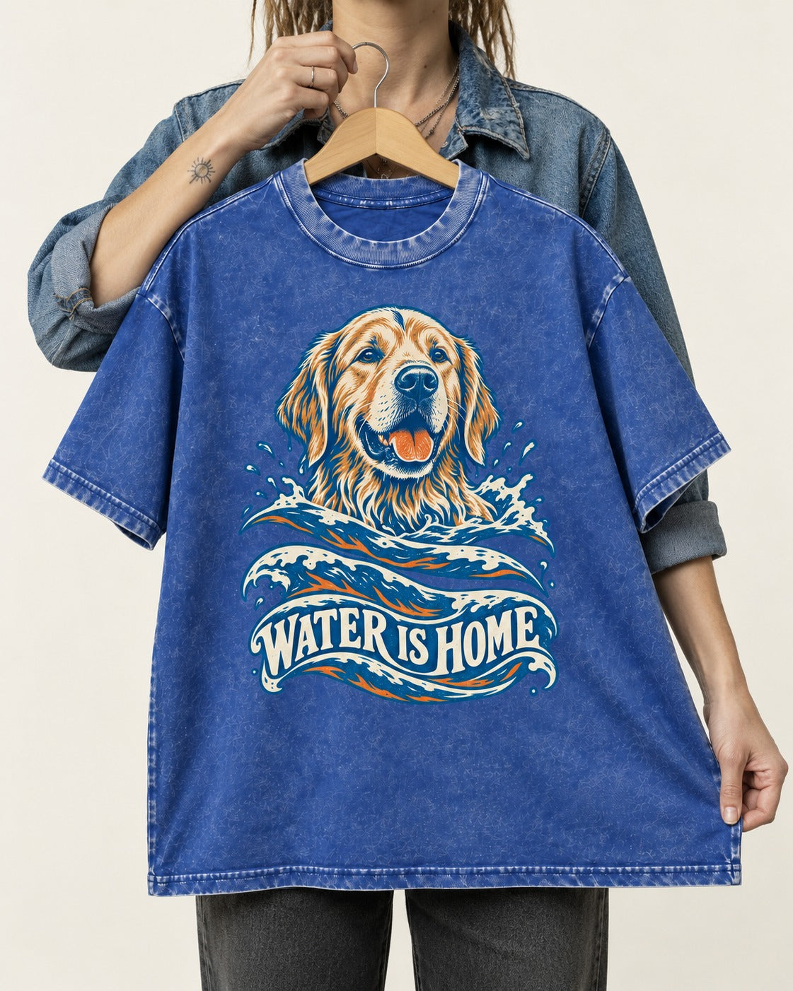 Golden Retriever Water Is Home Ocean Wave Graphic Washed Tee in Royal Blue, held up on a hanger