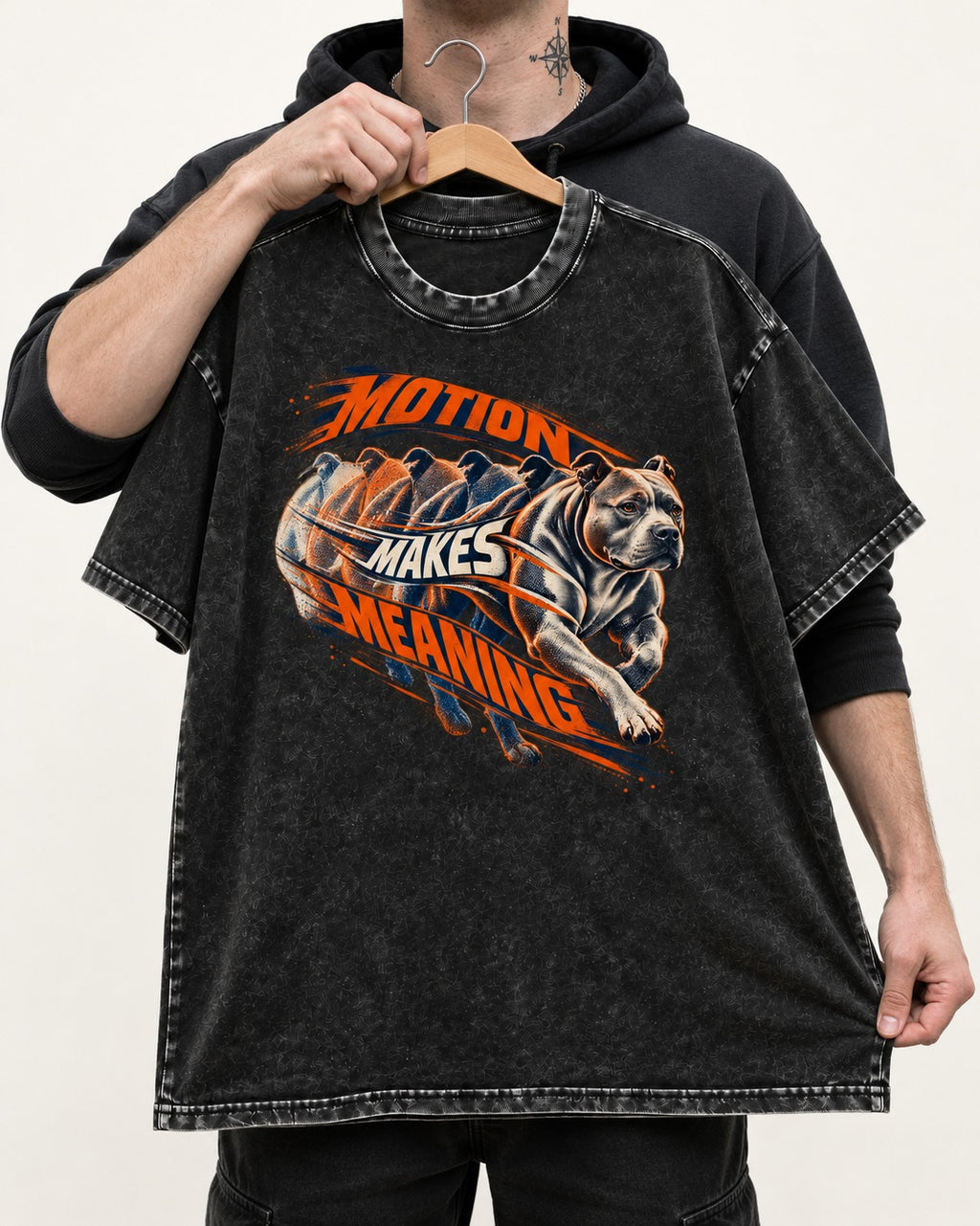 Pitbull Motion Makes Meaning Running Dog Graphic Washed Tee in Black, held up on a hanger