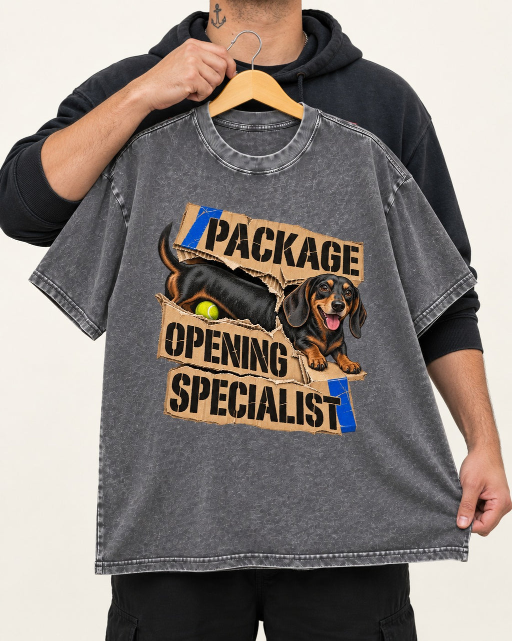 Dachshund Package Opening Specialist Washed Tee in Gray, held up on a hanger